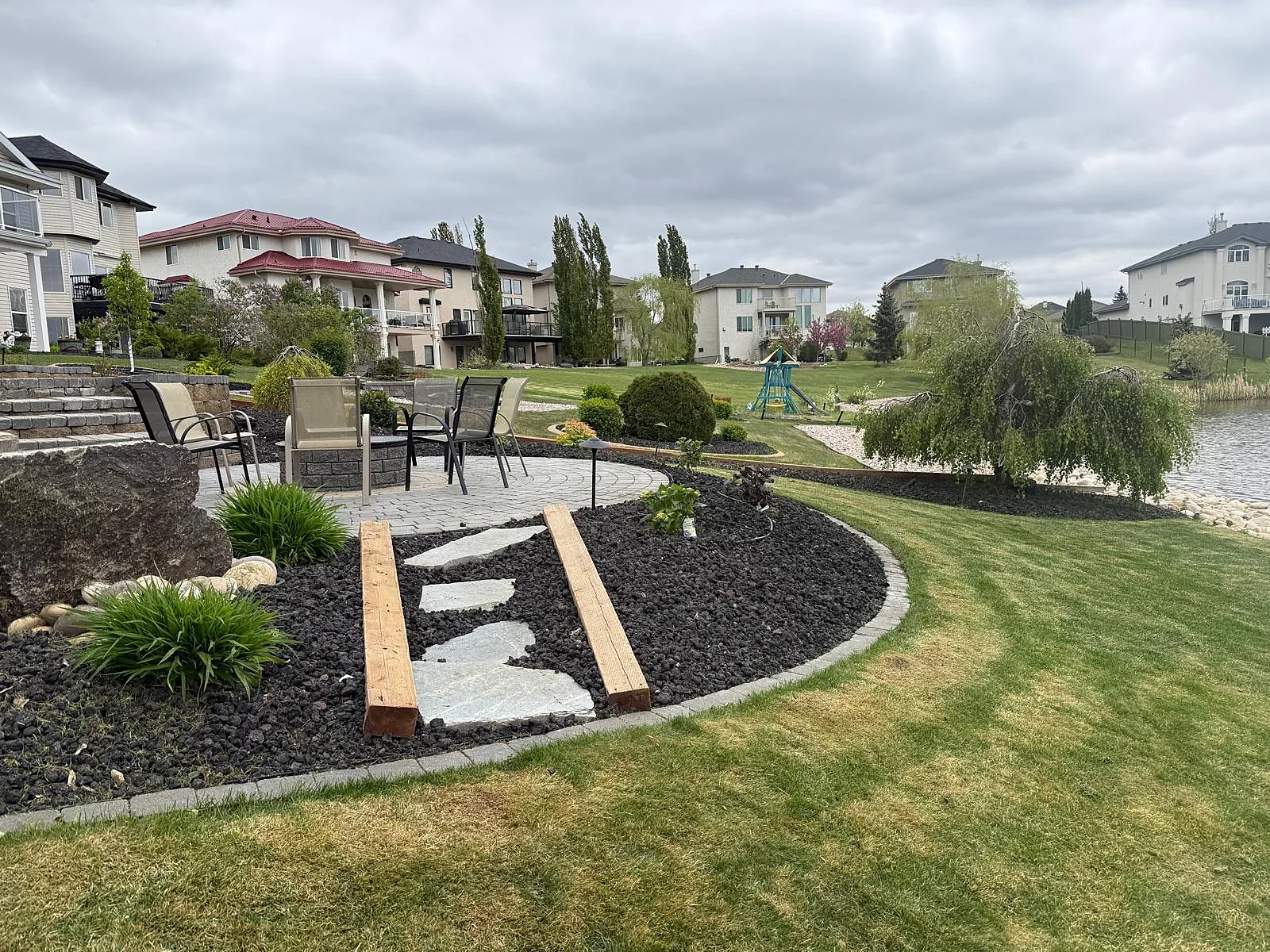 Wide view of decorative garden edging, planting beds and finished lawn