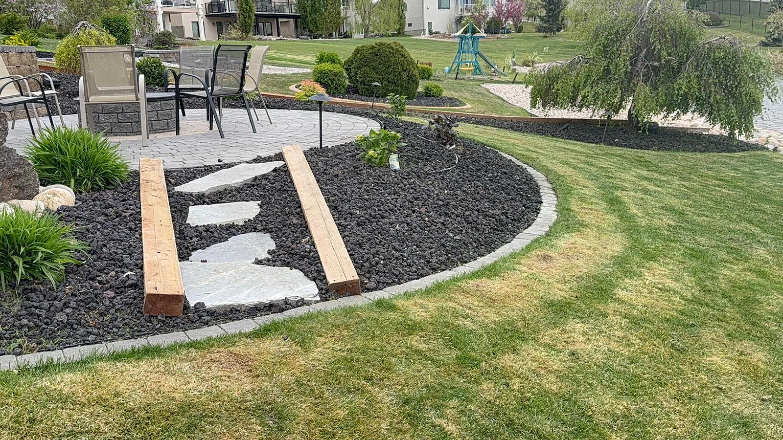 Decorative stone steps through a mulched garden bed