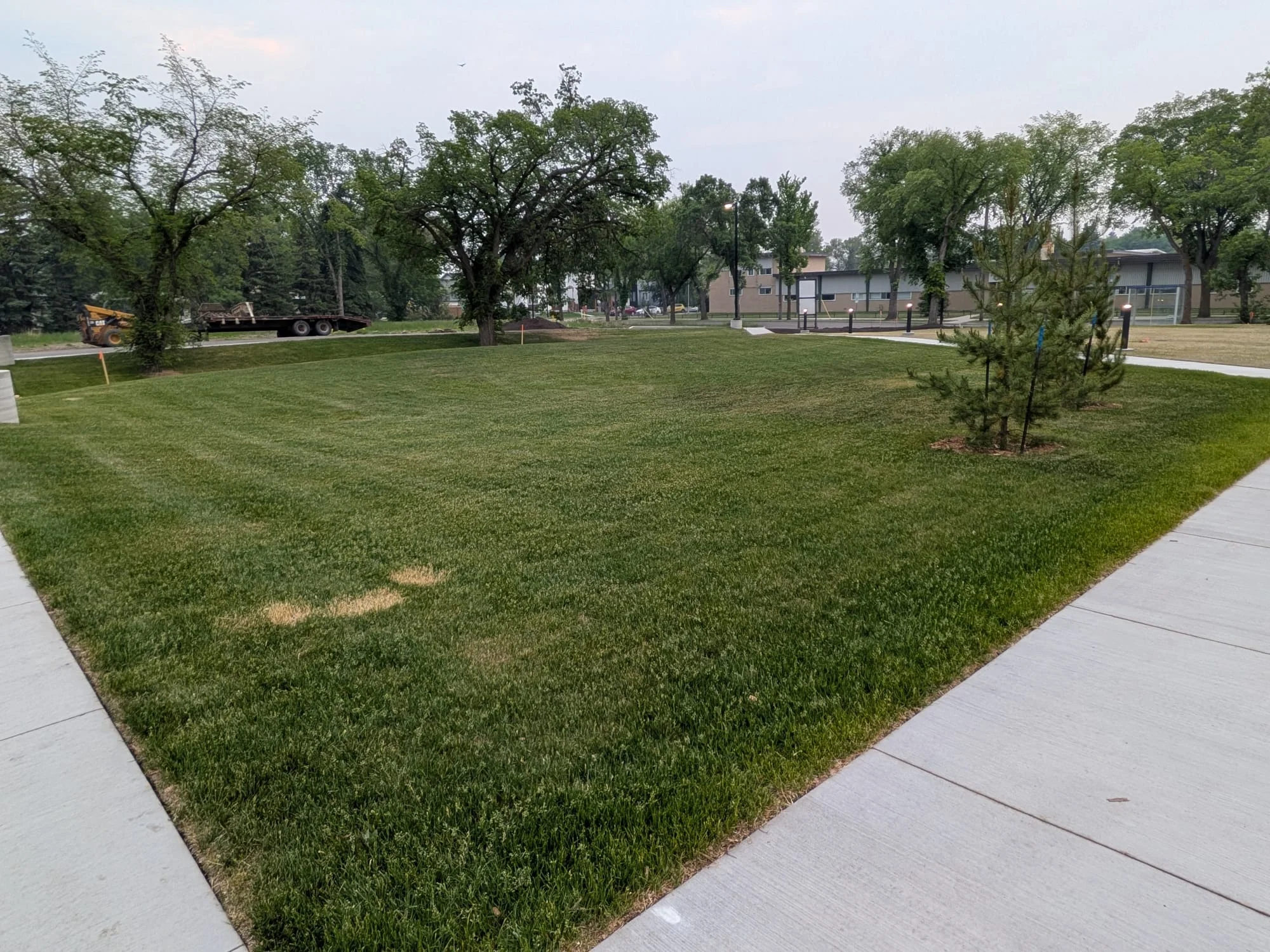 Open landscaped lawn and paved pathways