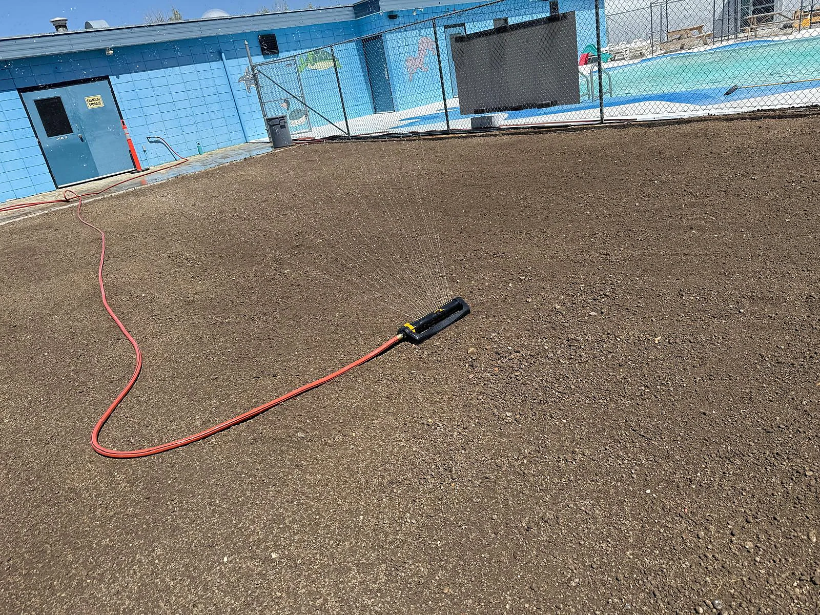 Sprinkler watering freshly prepared soil